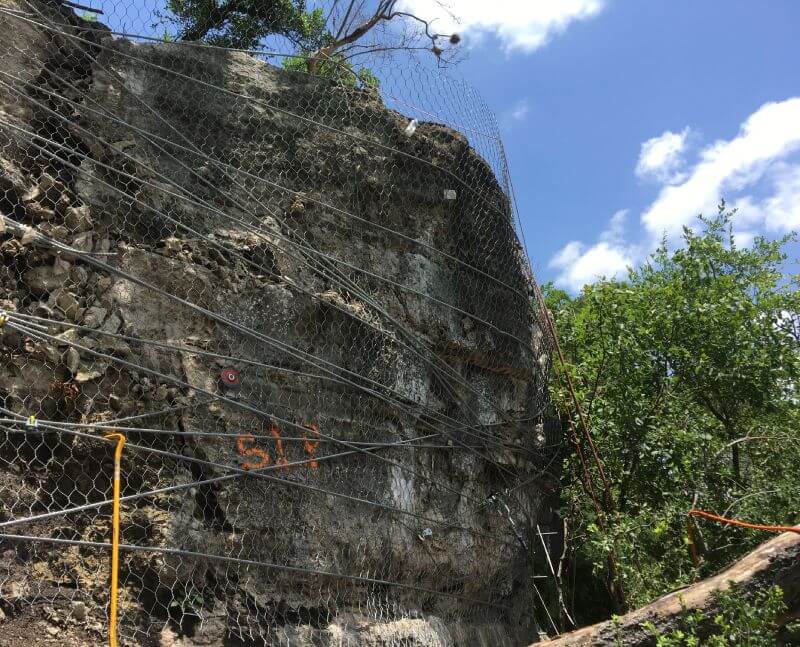 Rock scaling after installing a pinned drapery system